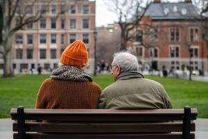 Elderly couple sitting on a park bench having a warm conversation with a scenic backdrop photo