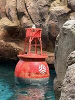 Sea floating signal, such as a buoy, bobbing gently on the water's surface, designed to enhance maritime navigation photo
