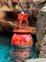 sea floating signal, such as a buoy, bobbing gently on the water's surface, designed to enhance navigation photo