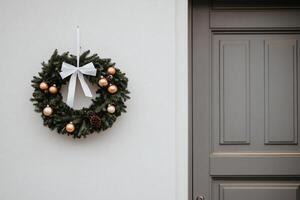 A decorative wreath with ornaments and a bow on a door. photo