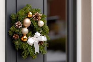 A festive wreath adorned with ornaments and pinecones on a door. photo