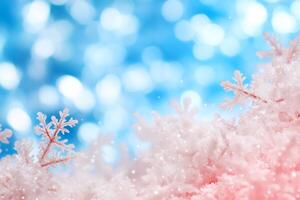A soft winter scene with pink snowflakes against a blue bokeh background. photo