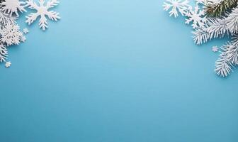 A winter-themed background featuring snowflakes and pine branches. photo