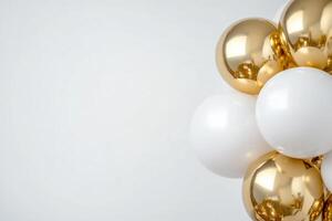 A cluster of shiny gold and white balloons against a plain background. photo