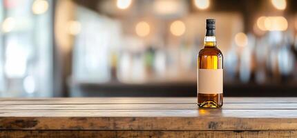 A bottle of whiskey on a wooden table in a blurred bar setting. photo