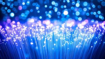 A vibrant display of glowing fiber optic strands against a blue backdrop. photo