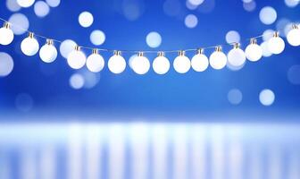 A string of glowing white lights against a soft blue background. photo