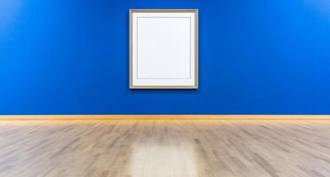 A minimalist art gallery with a blank frame on a blue wall. photo