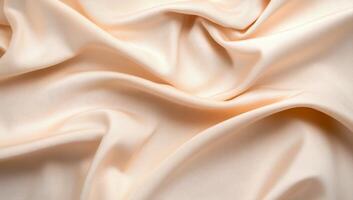 A close-up of soft, light peach satin fabric draped elegantly. photo
