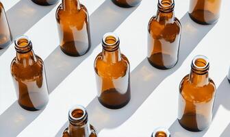 Many empty beer bottles are arranged on a white surface photo