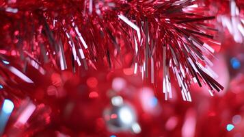Close-up of shiny red tinsel with blurred festive background. photo