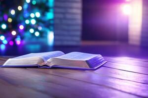 An open book rests on a wooden floor, with colorful lights in the background. photo