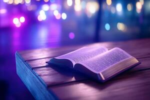 An open book rests on a wooden table with a blurred colorful background. photo