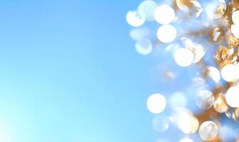 A blurred background with sparkling bokeh effects against a blue sky. photo