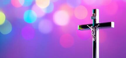 A silver crucifix against a colorful bokeh background. photo
