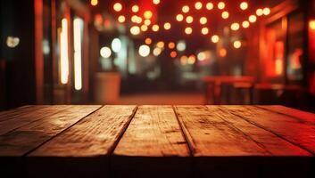A rustic wooden table in a dimly lit outdoor setting with string lights. photo