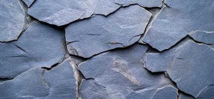A close-up view of textured blue slate stone with natural cracks. photo