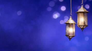 Two decorative lanterns glowing against a blurred blue background. photo