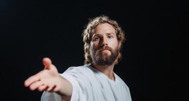 A figure in a white robe reaching out with an inviting gesture. photo