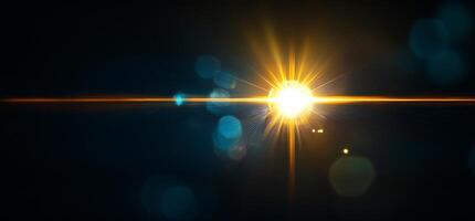 A bright starburst effect with lens flare and bokeh in a dark setting. photo
