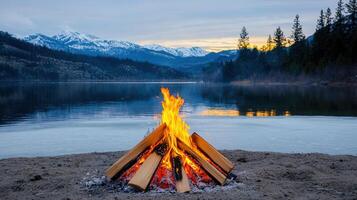 Majestic Bonfire on Frozen Lake Shore with Mountain View at Dusk photo
