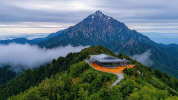 Majestic Mountain Peak with Modern Summit Building Panoramic View Foggy Landscape photo