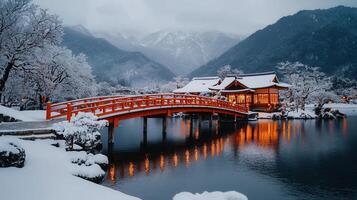 Serene Winter Scene Snow Covered Japanese Bridge Pavilion and Mountain Landscape photo