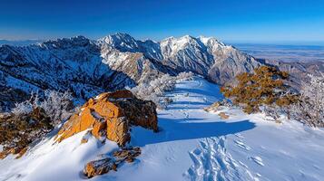 Majestic Winter Mountain Peak with Snow Covered Landscape and Footprints photo