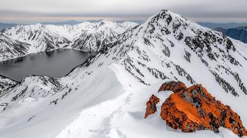 Stunning Panoramic View of Snow Covered Mountains Alpine Lake and Vivid Orange Rocks photo