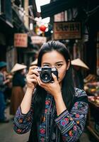 A woman taking a photo with a camera in a street