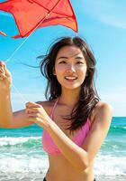A woman in a bikini holding a kite on the beach photo