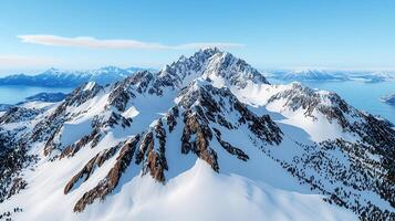 Majestic Winter Mountain Range Snow Covered Peaks and Coastal View photo