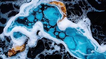Abstract Aerial View of Ocean Water with White Foam and Teal Bubbles photo