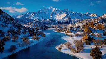 Stunning Aerial View of a Frozen River Winding Through a Snow Covered Mountain Valley in Winter photo
