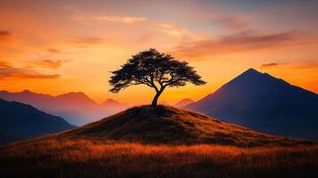 Majestic Sunset Landscape Lone Tree on Hilltop with Mountain Range photo
