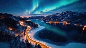 Scenic Winter Night Drive Aurora Borealis over Frozen Lake and Mountain Road photo