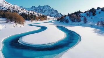 Stunning Aerial View of Serpentine River Frozen in Snowy Mountain Landscape photo