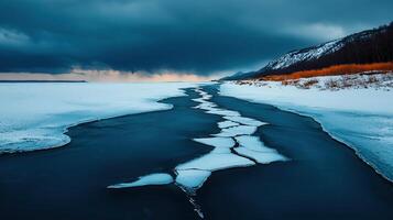 Dramatic Winter Landscape Frozen River Breaking Through Ice Snowy Banks Dark Clouds photo