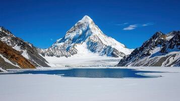 Majestic Snow Capped Mountain Peak with Glacial Lake and Winter Landscape photo