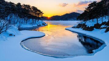 Serene Winter Sunset Over Frozen Lake with Snow Covered Banks and Pine Trees photo