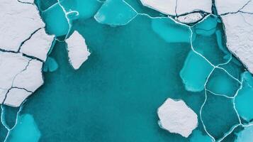Aerial View of Turquoise Water with Cracked Ice Winter Landscape Abstract Texture photo