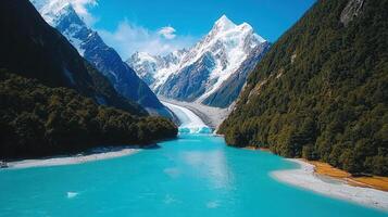 Stunning Turquoise Lake Surrounded by Majestic Snow Capped Mountains and Lush Green Forests photo