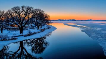 Serene Winter Sunset Landscape Snow Covered Trees Frozen River and Mountain Range photo
