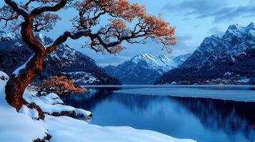 Serene Winter Landscape Snow Covered Mountains Frozen Lake and Majestic Tree photo
