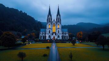 Majestic Gothic Cathedral at Dusk Illuminated Windows Serene Landscape photo