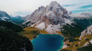 Majestic Alpine Lake Surrounded by Snow Capped Mountains and Lush Green Valley photo