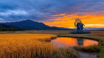 Serene Sunset Landscape Windmill in Golden Wheat Field with Mountain View photo