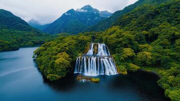 Serene Waterfall Cascading into Lush Green Mountain Lake photo