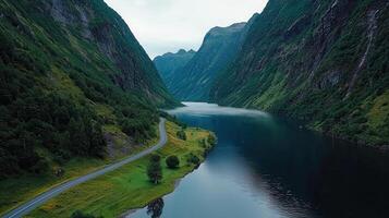 Scenic Winding Road Through Majestic Mountain Fjord Landscape photo