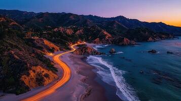 Scenic Coastal Highway at Sunset Dramatic Ocean View Light Trails on Beach Road photo